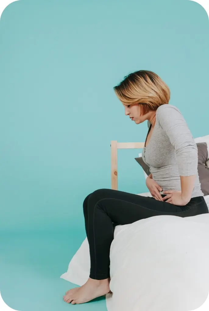 woman-sitting-with-hurting-stomach-1 Perimenopausal Bleeding and Heavy Periods | Dr Kelly Hankins
